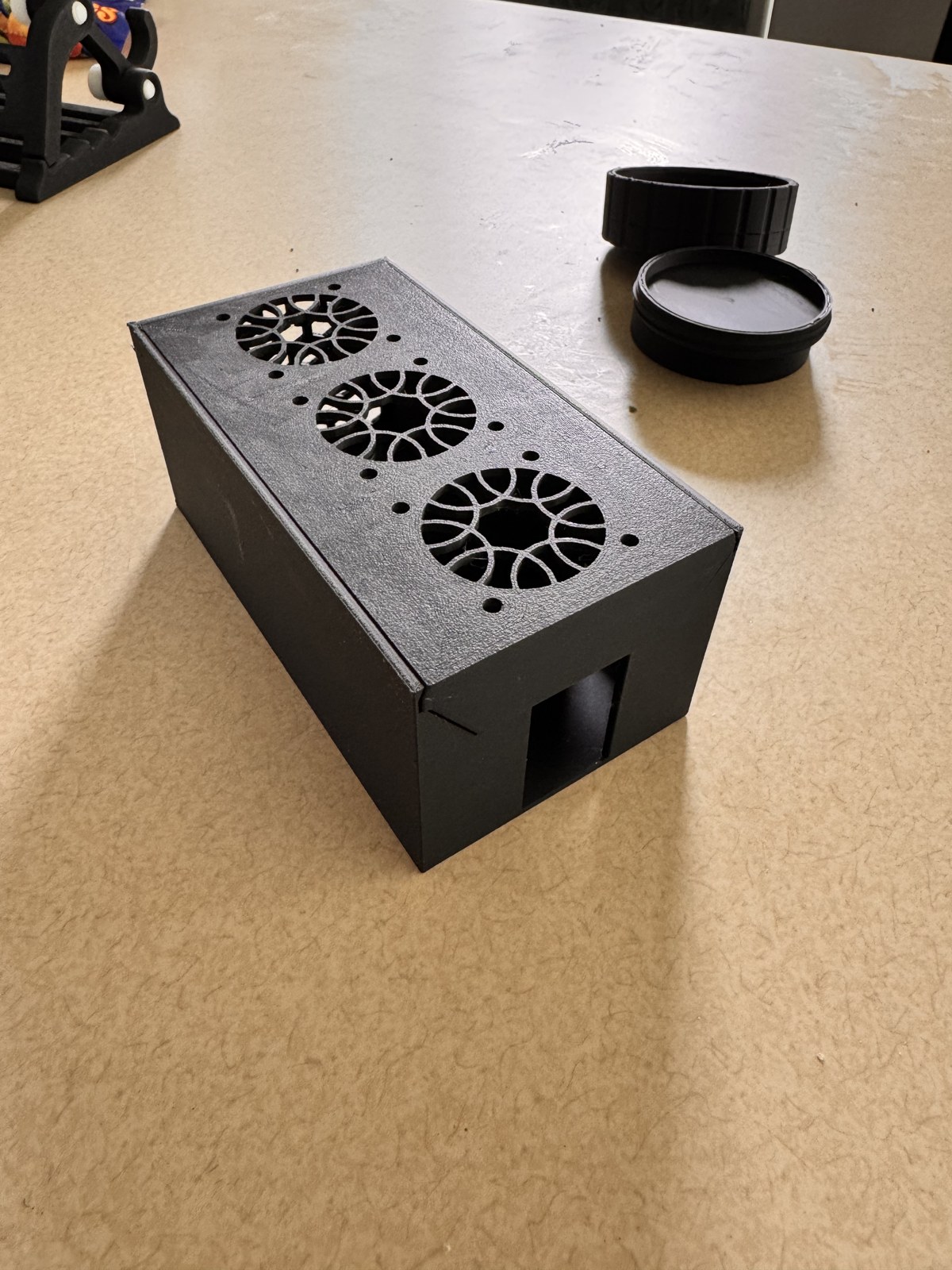Three quarter view of the assembled cooling box from the left showing the rectangular USB-C cutout at the front and the slide-in top plate seated flush with the shell