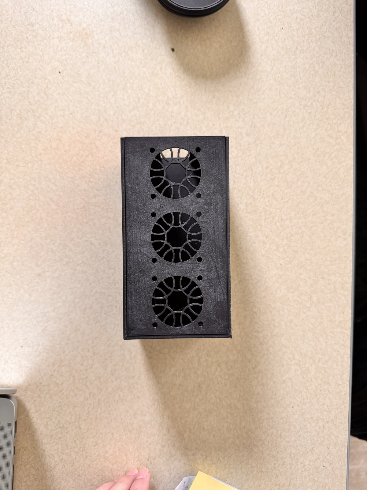 Top view of the assembled cooling box looking straight down, the three circular fan cutouts and surrounding bolt-hole pattern fully visible